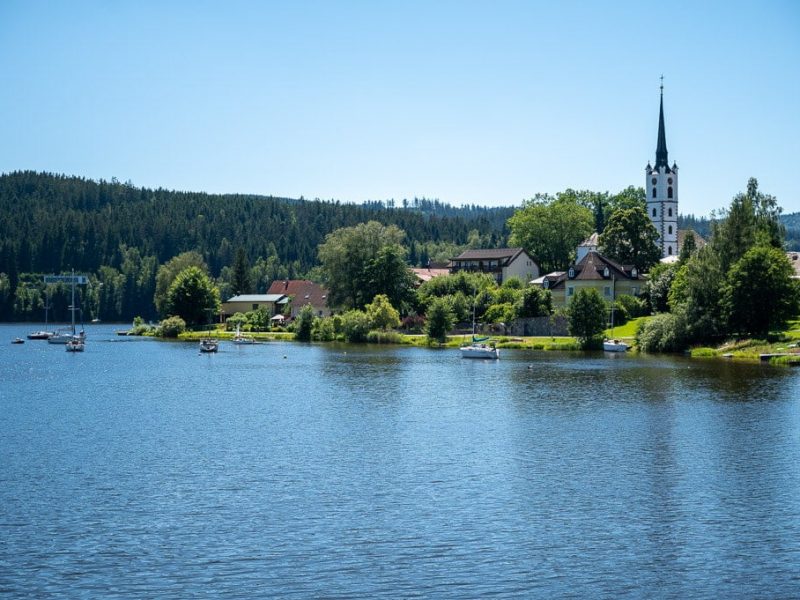 Lipno Lake-2 church steeple rising up on the shore of Lipno Lake